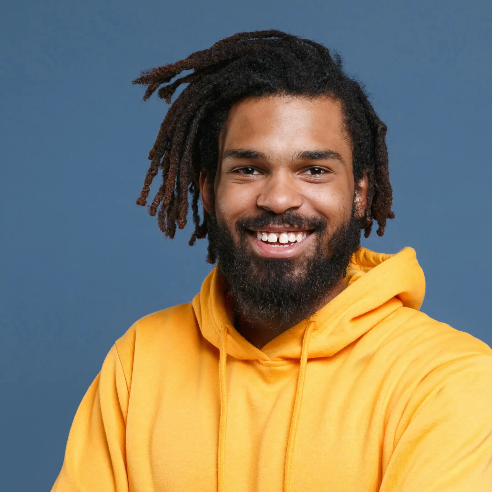 Guy with dreads in yellow hoodie